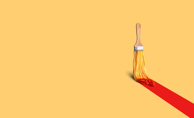 Photo collage of paint brush with spaghetti in red ketchup painting long red bold stripe on light...