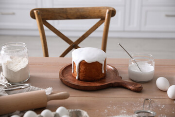 Traditional Easter cake and ingredients on table in kitchen