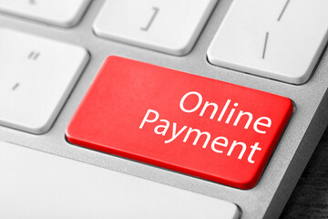 Fototapeta premium Modern laptop keyboard with text Online Payment on red button, closeup view