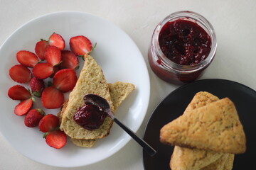 Home baked plain mildly sweet buttermilk scones served along with homemade strawberry jam and fresh...