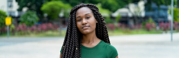 Smiling young adult woman from Africa with amazing hairstyle