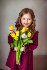 girl with a bouquet of tulips in a beautiful purple dress, spring, flowers, children, March, beauty