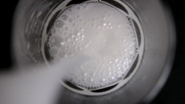 Pouring traditional Mexican horchata water into a glass