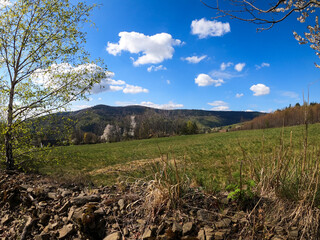 Landscape of Beskidy mountains in Poland taken in sunny spring. Mountain panorama captured during trekking.