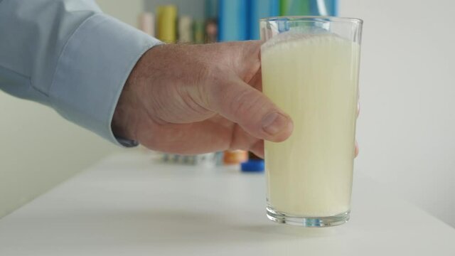 Sick Man Suffering a Big Headache Drink an Effervescent Tablet Dissolved in a Glass with Water