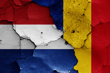 flags of Netherlands and Romania painted on cracked wall