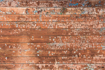 An old wooden surface with paint. The background of the boards