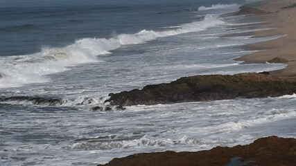 The sea hitting the shore in the historic site cape coast Ghana where the ships shipped slaves. The film was taken from the back of the cape coast castel - Powered by Adobe