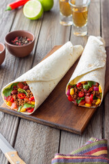 Burritos with meat, beans, corn, tomatoes, onions and chilli. Mexican food. Recipe.