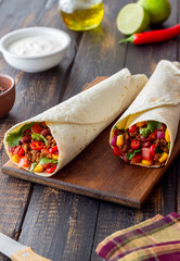 Burritos with meat, beans, corn, tomatoes, onions and chilli. Mexican food. Recipe.