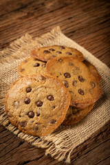 Delicious chocolate cookies on wooden table.