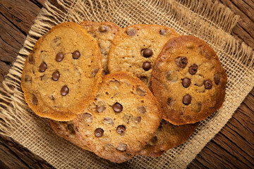 Delicious chocolate cookies on wooden table.