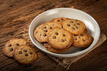 Delicious chocolate cookies on wooden table.