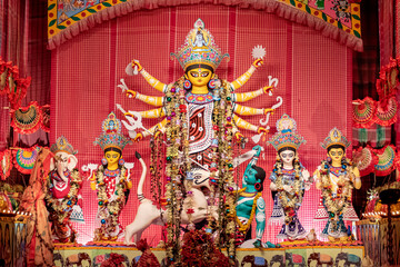 Idol of Goddess Devi Durga at a decorated puja pandal in Kolkata, West Bengal, India. Durga Puja is...