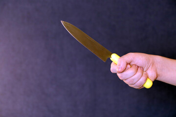 hand holding a yellow knife
