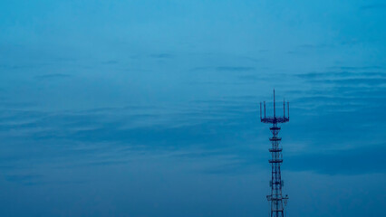 Obraz premium TV tower and skyline at dusk. Low Angle View Of Communications Tower Against Clear Sky. Space for text.