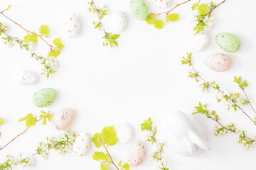 Naklejka na ściany i meble Flat lay easter composition with spring flowers and easter eggs on a white background
