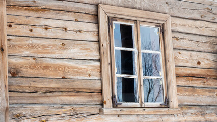 Boarded up windows on the old wooden wall of the house. Carving adorns the old window. Image for design. Countryside concept.
