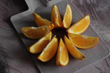 Fototapeta na wymiar Juicy organic orange on cutting board. Healthy vegetarian food