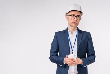 Tired handsome caucasian engineer with a cup of hot drink isolated over white background