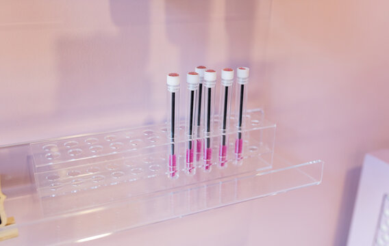 Collection of small eyelash brushes in individual case placed on vanity table in modern light beauty salon