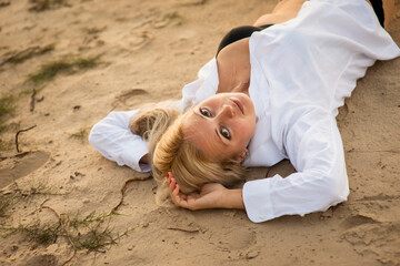 blonde girl in white shirt on the beach, selective focus