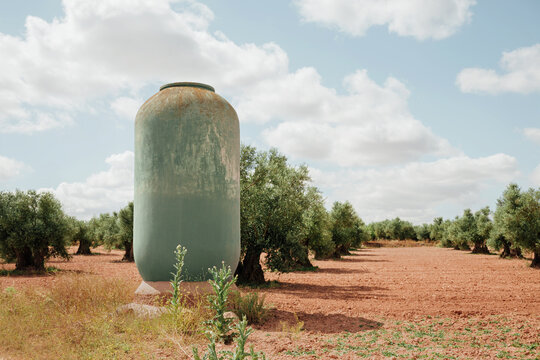Water tank in the middle of an olive grove