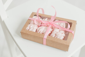 meringue box decorated with ribbon on white table