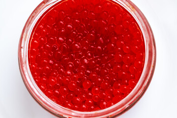 red salted salmon caviar in a jar on a white background