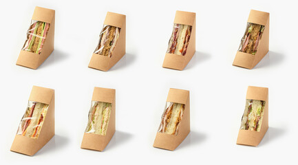Sandwich toasts with various fillings in paper ecological boxes craft take away, on a white background with a shadow.