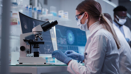 Female doctor working in laboratory. Studying coronavirus and DNA samples