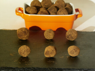 Tasty Several Truffles in a rectangular shape on black slate board