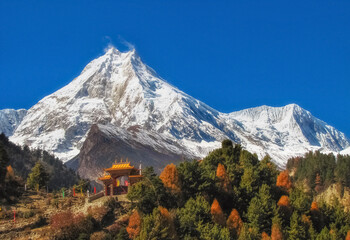 Beautiful peak Manaslu in the autumn Himalaya mountains in Nepal with a Buddhist monastery at the foot
