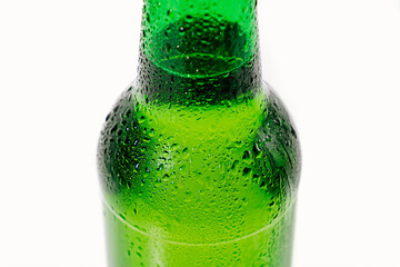 green glass bottle covered with water drops. condensate