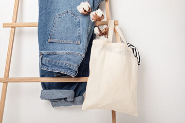 Mockup with organic cotton tote bag and jeans. Sustainable ethical consumption idea