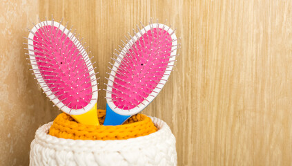 two colored hair combs in a basket in the bathroom. Hygiene and healthy lifestyle concept. Copy...