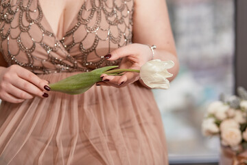 Girl with big neckline and white tulip close up. Spring concept