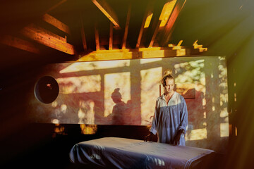 Male reiki master standing in studio for practicing traditional Japanese form of alternative medicine energy healing