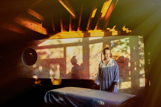 Male reiki master standing in studio for practicing traditional Japanese form of alternative medicine energy healing
