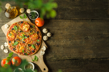 Homemade fresh vegetarian pizza with cheese, mushrooms and olives on wooden background