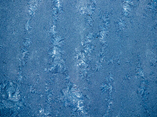 Ice crystals in the detail on a window glass in winter time