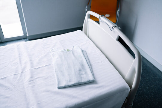 Empty bed in light equipped ward in contemporary hospital
