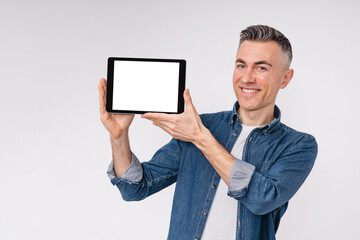 Cheerful modern mature man showing tablet`s screen isolated over white background