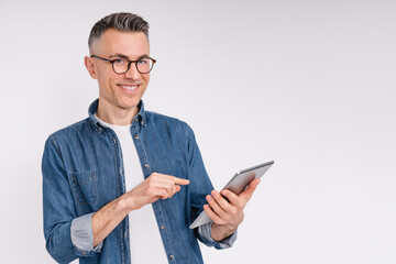 Cheerful caucasian mature man using tablet isolated over white background