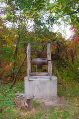 Old wooden well in an autumn garden in an ordinary rural house, Ukraine