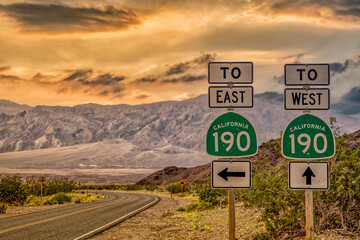 Death Valley Highway sign, Highway 190 California to east and west at sunset