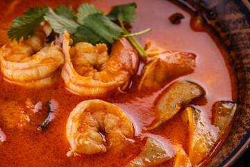 Tom Yam Kung soup. Spicy Thai soup with shrimp, coconut milk and chili pepper in bowl.