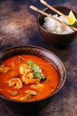 Tom Yam Kung soup. Spicy Thai soup with shrimp, coconut milk and chili pepper in bowl.