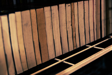 Vintage retro bookshelf in public library with many books. Book stack in the library room for education as concept.