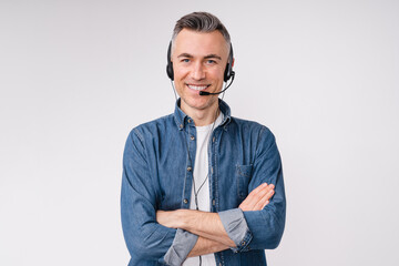 Confident mature man with it support headset and arms crossed isolated over white background - obrazy, fototapety, plakaty